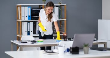 stock-photo-young-worker-cleaning-desk-with-rag-in-office-1619486272-transformed